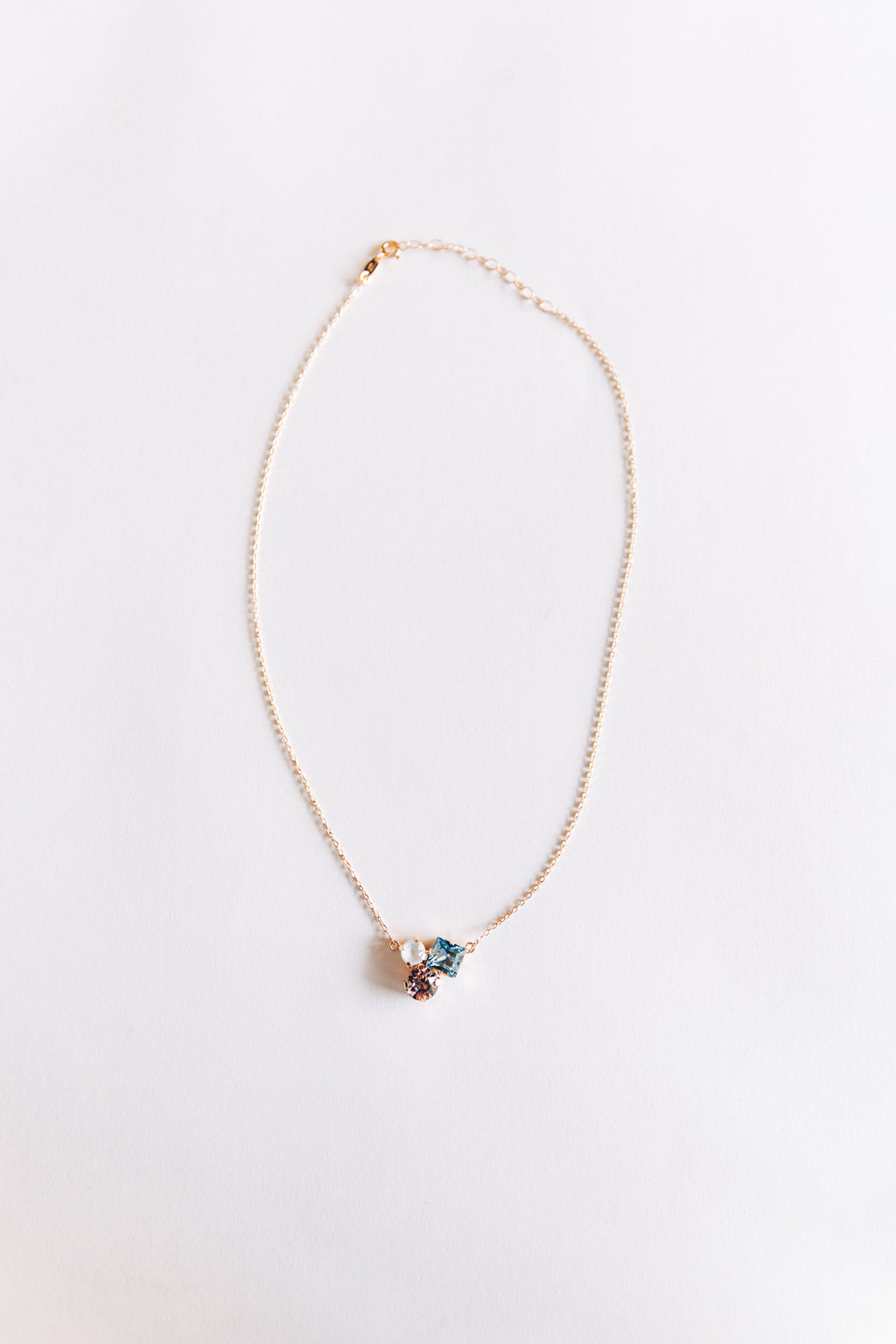 This image displays the Ivy necklace, featuring a delicate design with a fine rose gold-tone chain. 