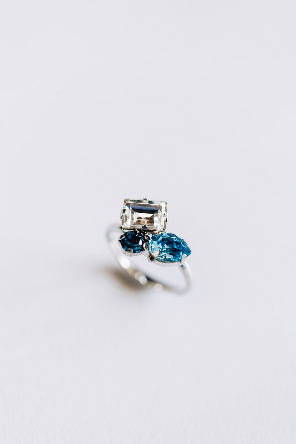 hypoallergenic Silver ring with white and blue crystals on a white background